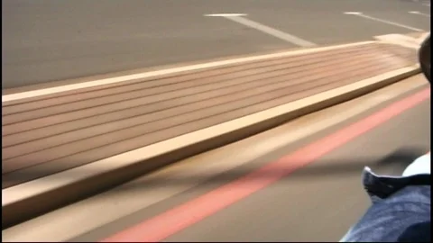 Scooter being driven down a street with parked cars Video stock 95614054