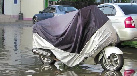 A scooter in the boot standing in water Stock Footage 64259942