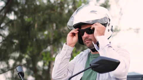 The scooter driver puts on sunglasses. Stock Footage 313198779