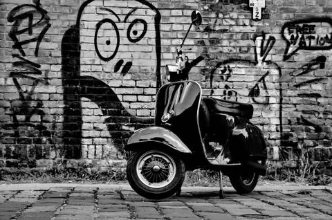Scooter in front of a wall Stock Photos