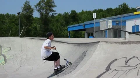Scooter kid does a scooter flip trick Stock Footage 8959278
