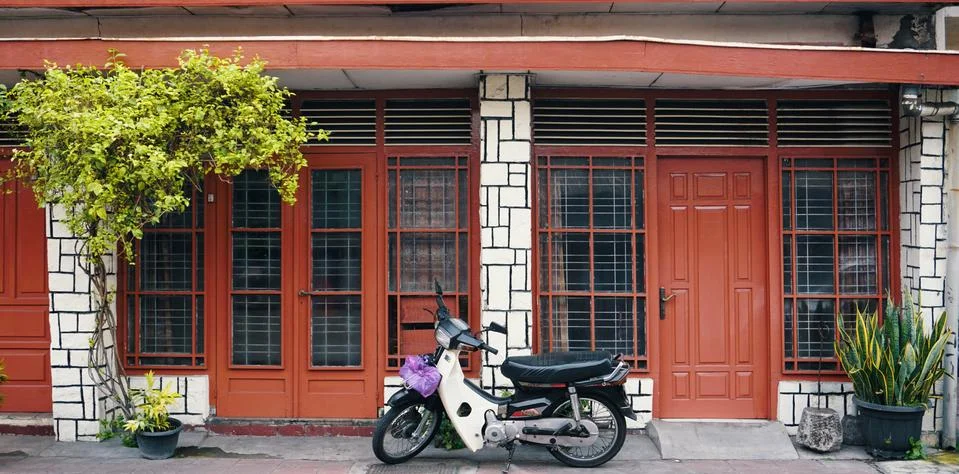 Scooter parked between plants Stock Photos