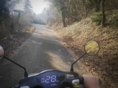 Scooter Ride Through a Forest Path 스톡 사진