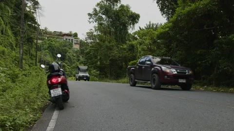 Scooter stands on the side of the road in the middle of the jungle Phuket Stock Footage 223822703