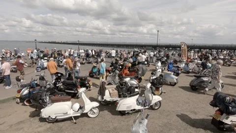 Scooters on display, Ryde seafront, IOW Scooter Rally 2022, pier behind Stock Footage 238480139