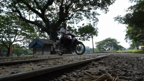 Scooters pass over Shan State railway, slowmotion, Burma, Asia in 4K Stock Footage 94881855