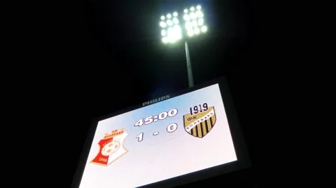 Scoreboard Display And Reflector Lights On Football Stadium At Evening Time Stock Footage 56185058