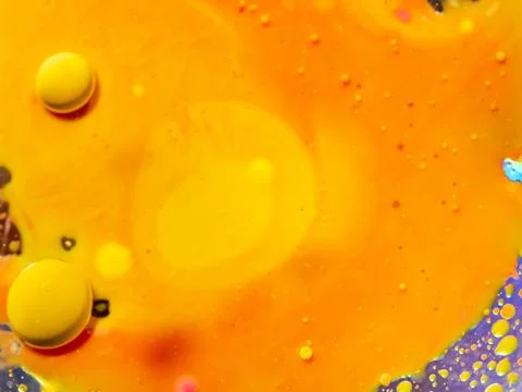 Scores of small bubbles and two big spheres on abstract orange background. Close Foto stock