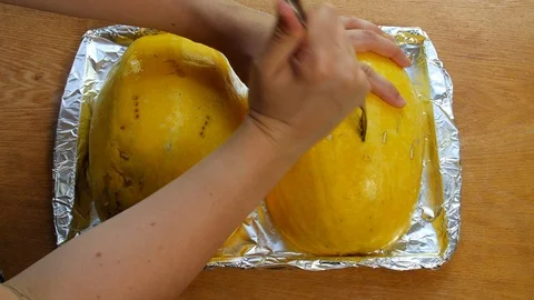 Scoring and preparing spaghetti squash. Stock Footage 106607338