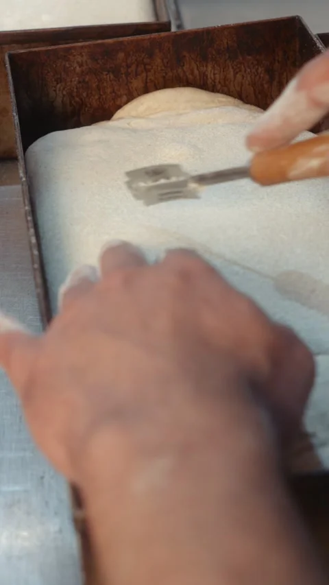 Scoring bread dough with a blade before baking Video stock 344313422