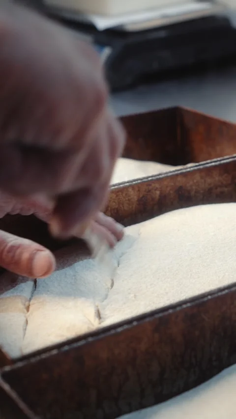 Scoring Bread Dough in Metal Baking Tray with Blade Slow Motion Video stock 345040282