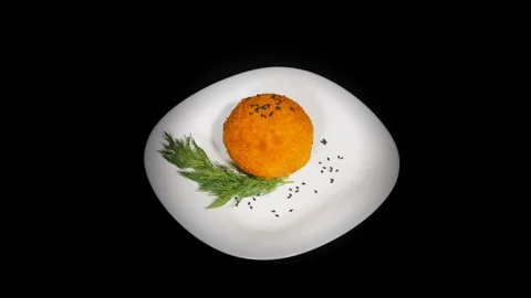 Scotch egg in the spinning table isolated on black background in black plate Vidéo 104722396