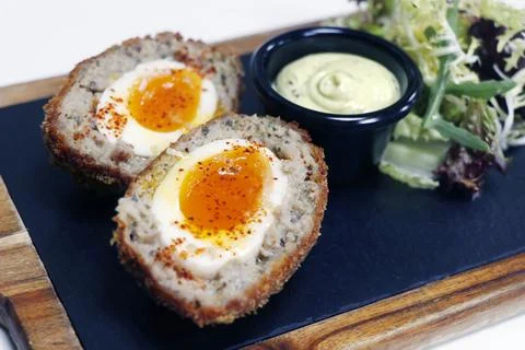 Scotch eggs, deep fried boiled egg coated with mixture of pork mince with hon Stock Photos