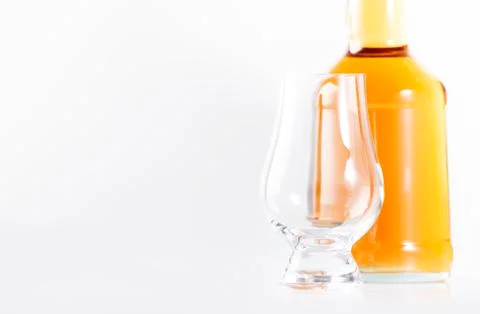 Scotch Whiskey without ice empty glasses and bottle, white background, copy s Stock Photos