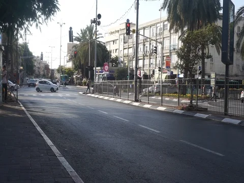 Scotter is crossing red light - dangerous ride - Sokolov St. Holon Israel Stock Footage 82009098