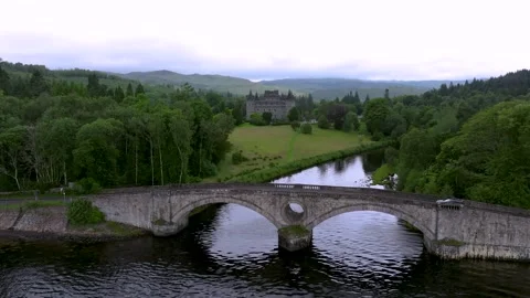 A Scottish bridge over a river with a castle in the background Stock Footage 306490595