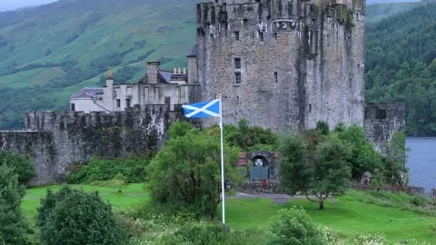 A Scottish castle with Scottish flag on top of it Stock Footage 306492759