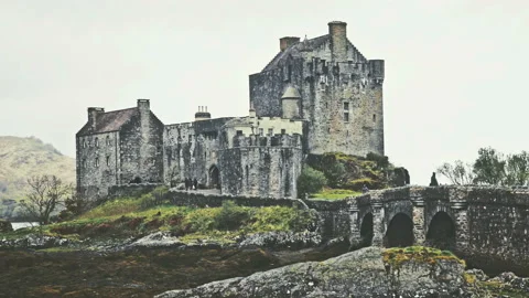 Scottish castle surrounded by mountains Stock Footage 94656038