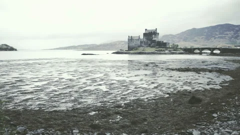 Scottish castle surrounded by mountains Stock Footage 94656429