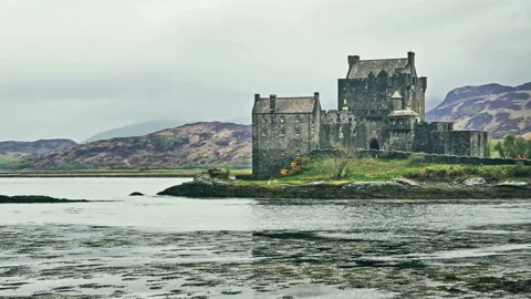 Scottish castle surrounded by mountains Stock Footage 94658636