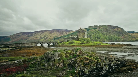 Scottish castle surrounded by mountains Stock Footage 94658909