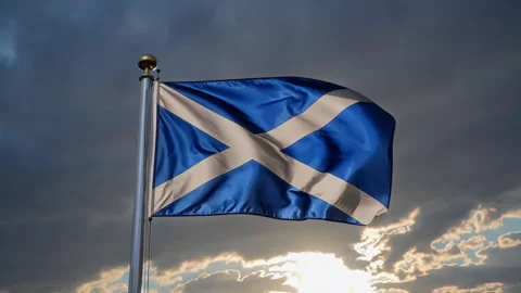 The Scottish flag waving against a dramatic sky, evoking pride and cultural Video stock 306176399