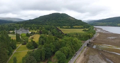 Scottish Forested Hill Pulling Back Drone Shot with a Small Highway 스톡 동영상 97592804
