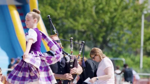 Scottish Highland Dancer Performs with Bagpipe Music Outdoors Stock Footage 314538592