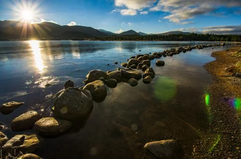Scottish-Highlands-frozen-lake-lense-flare Stock Photos