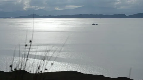 Scottish loch with a boat crossing Stock Footage 219513853
