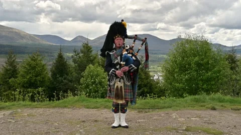 Scottish old man  performing on the bagpipe 4k footage Stock Footage 141471667