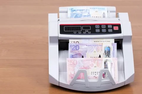 Scottish Pounds in a counting machine Stock Photos