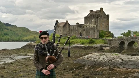Scottish young woman performing on the bagpipe 4k footage Stock Footage