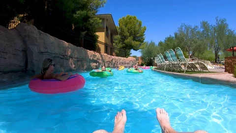 Scottsdale, AZ USA - 9/2/2019: Woman and Children Floating Down a Lazy River Stock Footage