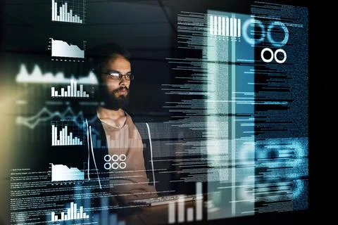 Scouring through reams of data. a young computer programmer working on source Stock Photos