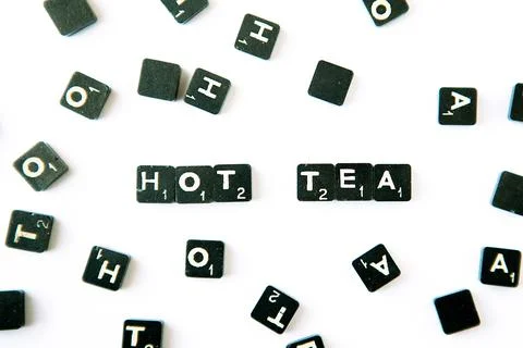 Scrabble. Table game. Hot tea words. Scrabble character on white background Stock Photos