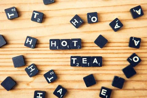 Scrabble. Table game. Hot tea words. Scrabble character on wood background Foto stock