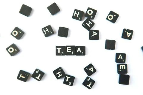Scrabble. Table game. Tea word. Scrabble character on white background Stock Photos