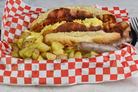 Scramble egg and bacon breakfast sub with home fries Stock Photos
