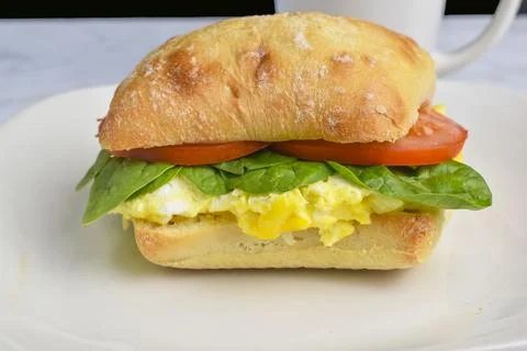 Scramble  egg with  spinach and tomato  on a roll Stock Photos