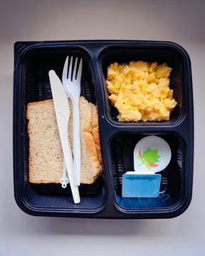 Scramble eggs with bread, butter and jam served in a breakfast bento box Stock Photos