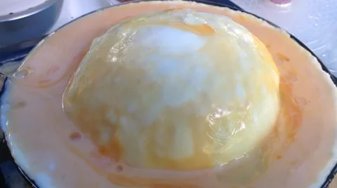 Scrambled Chicken Eggs Poured in a huge bubble in the pan Stock Footage 58299540