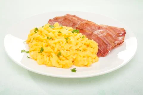 Scrambled egg and bacon breakfast Stock Photos