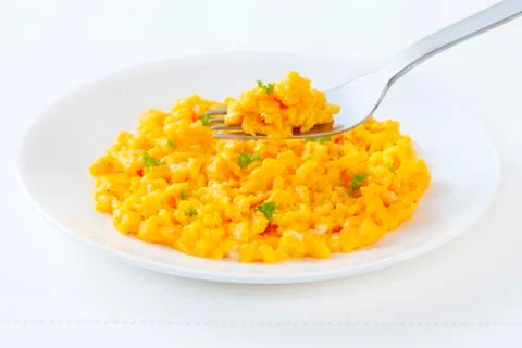 Scrambled egg and  fork lifting a forkful Stock Photos