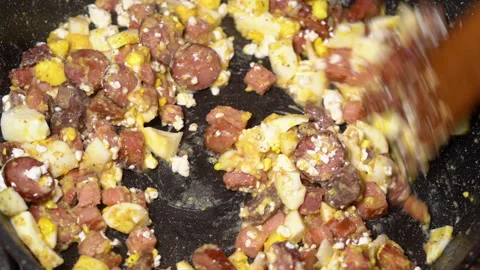 Scrambled egg cooking process with meat in a frying pan Stockbeeldmateriaal 250614449