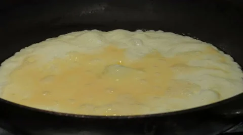 Scrambled egg omelet cooking in frying pan, close up Video stock 68168901