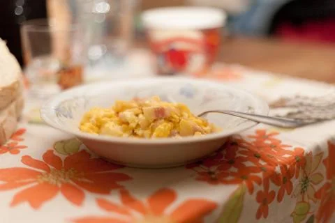 Scrambled eggs and bacon in ceramic dish with fork an Italian Food Made in It Stock Photos