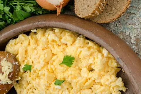 Scrambled eggs and bread Stock Photos
