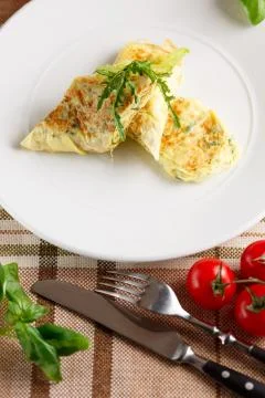 Scrambled eggs with arugula Stock Photos