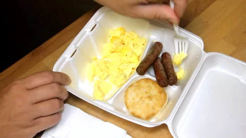 Scrambled Eggs With Bacon And A Biscuit In A Styrofoam Tray Stock Footage 307609631